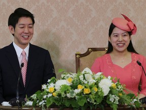 Japanese Princess Ayako (R), the third daughter of the late Prince Takamado, and her fiance Kei Moriya attend a press conference to announce their engagement at the Imperial Household Agency in Tokyo on July 2, 2018.
