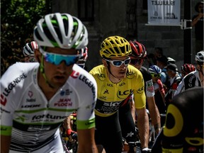 Great Britain's Geraint Thomas (C-L), wearing the overall leader's yellow jersey, takes the start with the pack of the twelfth stage of the 105th edition of the Tour de France cycling race, between Bourg-Saint-Maurice - Les Arcs and l'Alpe d'Huez, on July 19, 2018.