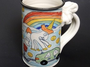 This undated handout photo obtained July 22, 2018 courtesy of Tom Edwards Pottery, shows a "Farting Unicorn" electric car magic mug. Elon Musk has reached an agreement with a US potter who accused him of using his farting unicorn design on Tesla products without permission.  Tom Edwards, of Colorado, wrote on his website on July 20, 2018 the issue had been resolved "in a way that everyone feels good about!" while Musk tweeted a screenshot of the same statement. The story began last year after the billionaire founder of the electric car firm and SpaceX tweeted a picture of Edwards' colorful mug, which depicts a crudely drawn unicorn against a rainbow, with smiley-face emojis in the background.The mythical creature is seen passing wind into a funnel that is connected to a car. "Electric cars are good for the environment because electricity comes from magic," reads the back. Musk called it "maybe my favorite mug ever" and the publicity led to a slight bump in sales for Edwards, who was happy the South African-born entrepreneur, often hailed as a leading tech innovator and visionary, was a fan of his work.