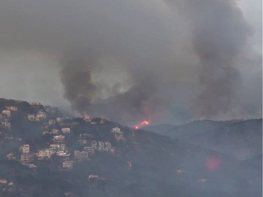 This handout picture released by the Hellenic Ministry of Defence on July 24, 2018 shows an aerial view of fire in Mati. The death toll from the wildfire ravaging the seaside areas around Athens has increased to 60 in Greece's deadliest blaze in more than a decade, on July 24, 2018.