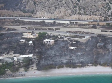 This handout picture released by the Hellenic Ministry of Defence on July 24, 2018 shows an aerial view of a burnt urban area following fire in Kineta, western Greece.