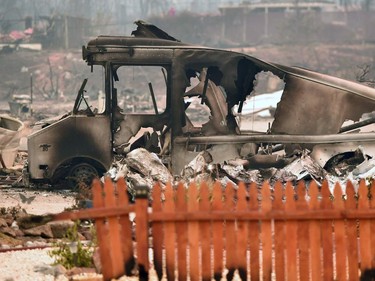 A burned vehicle is seen amidst a destroyed neighborhood after the Carr fire passed through the area of Lake Keswick Estates near Redding, California on July 28, 2018. Five people have died and more than 500 structures have burned as wind-whipped flames tore through the region.  The US federal government approved aid Saturday for California as thousands of firefighters battled to contain a series of deadly raging wildfires that have killed six people and destroyed hundreds of buildings.