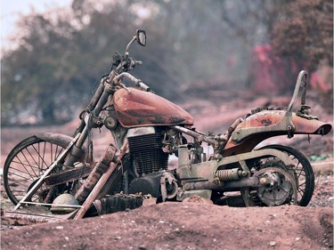 A burned motorcycle sits on a destroyed property after the Carr fire passed through the area of Lake Keswick Estates near Redding, California on July 28, 2018.  The US federal government approved aid Saturday for California as thousands of firefighters battled to contain a series of deadly raging wildfires that have killed six people and destroyed hundreds of buildings.