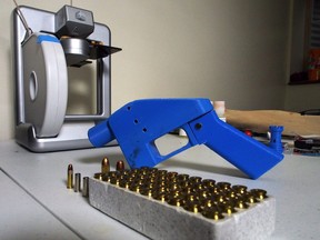 In this file photo taken on July 17, 2013 a Liberator pistol appears next to the 3-D printer on which its components were made in Hanover, Maryland.