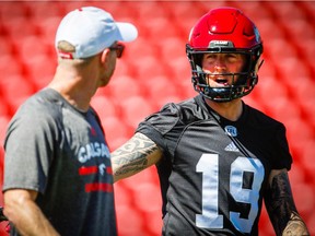 Stampeders head coach David Dickenson and quarterback Bo Levi Mitchell talk during practice earlier this week. Al Charest/Postmedia