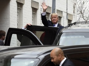 Republican presidential candidate Donald Trump waves as he gets into his vehicle in Washington, Thursday, March 31, 2016, following a meeting at the Republican National Committee.