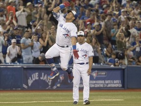 Toronto Blue Jays' Yangervis Solarte celebrates rounding third base after hitting a three run home run against the New York Mets in the seventh inning of their interleague MLB baseball game in Toronto on Tuesday, July 3, 2018.