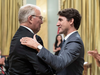 Bill Blair is congratulated by Prime Minister Justin Trudeau after being sworn in as Minister of Border Security and Organized Crime Reduction on July 18, 2018.