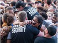 Security helps a woman out of the crushing huge crowd during last years Bluesfest.