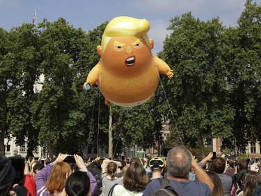 A six-meter high cartoon baby blimp of U.S. President Donald Trump is flown as a protest against his visit, in Parliament Square in London, England, Friday, July 13, 2018. Trump is making his first trip to Britain as president after a tense summit with NATO leaders in Brussels and on the heels of ruptures in British Prime Minister Theresa May's government because of the crisis over Britain's exit from the European Union.