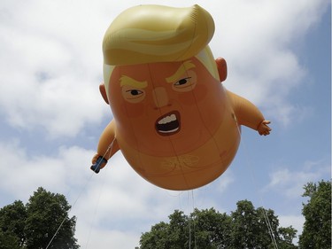 A six-meter high cartoon baby blimp of U.S. President Donald Trump is flown as a protest against his visit, in Parliament Square in London, England, Friday, July 13, 2018. Trump is making his first trip to Britain as president after a tense summit with NATO leaders in Brussels and on the heels of ruptures in British Prime Minister Theresa May's government because of the crisis over Britain's exit from the European Union.