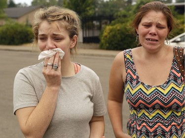 CORRECTS SPELLING TO SHERRY, NOT SHERRI-Sherry Bledsoe, left, cries next to her sister, Carla, outside of the sheriff's office after hearing news that Sherry's children, James and Emily, and grandmother, Melody Bledsoe, were killed in a wildfire Saturday, July 28, 2018, in Redding, Calif.
