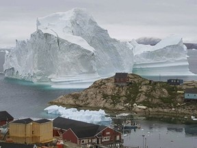 A huge iceberg, near the village of Innarsuit, on the northwestern Greenlandic coast has residents in houses near the shore prepared for an evacuation.