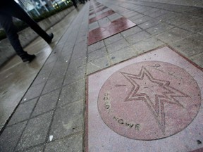 Pedestrians walk past Gordie Howe's newly fixed star on Canada's Walk of Fame in Toronto Wednesday, December 1, 2010. Canada's Walk of Fame stars might be headed to a new, nearby galaxy. CEO Jeffrey Latimer says the Walk of Fame is in talks with a city of Toronto councillor to make the stars a part of a revitalization plan for the downtown John Street strip.THE CANADIAN PRESS/Darren Calabrese