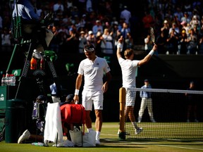 Roger Federer walks to his chair after losing to Kevin Anderson at Wimbledon on July 11.