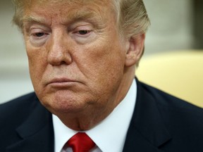 President Donald Trump listens during a meeting with European Commission president Jean-Claude Juncker in the Oval Office of the White House, Wednesday, July 25, 2018, in Washington.