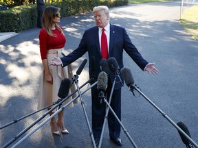 First lady Melania Trump looks on as President Donald Trump speaks with reporters before boarding Marine One on the South Lawn of the White House, Tuesday, July 10, 2018, in Washington.