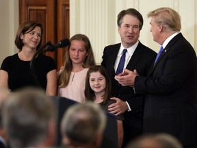 President Donald Trump greets Judge Brett Kavanaugh his Supreme Court nominee, in the East Room of the White House, Monday, July 9, 2018, in Washington.