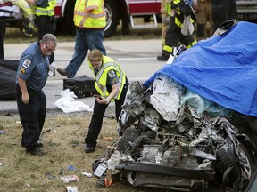 Paramedics work the scene of a deadly car crash on Route 1 near Townsend, Del., Friday, July 6, 2018.