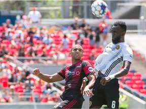 Tony Taylor of Ottawa Fury FC, left, and Hugh Roberts of Pittsburgh Riverhounds, right, contend for an aerial ball.