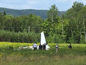 This photo provided by WVII-TV/ABC7 shows the tail of a small plane that crashed near Greenville Municipal Airport in Greenville, Maine, on Monday. WVII-TV/ABC7 via AP