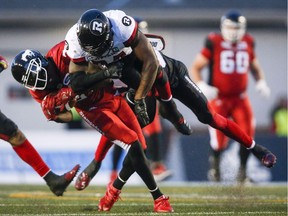 The Redblacks' Kyries Hebert, right, slams into the Stampeders' DaVaris Daniels last Thursday in Calgary, drawing not only a 15-yard penalty for unnecessary roughness, but also a one-game suspension levied on Friday.