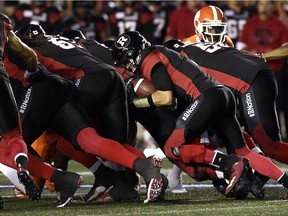 The Redblacks' Trevor Harris (7) attempts a quarterback sneak during the first half of Friday's game against the Lions.