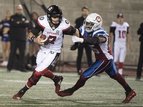 Redblacks QB Trevor Harris tries to elude Alouettes defensive end Jamaal Westerman during the second half of play in Montreal on Friday night.