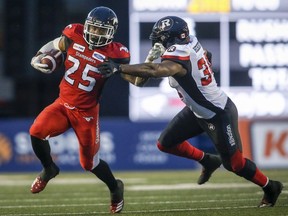 Ottawa Redblacks' Kyries Hebert, right, grabs for Calgary Stampeders' Don Jackson, during second half CFL football action in Calgary, Thursday, June 28, 2018.