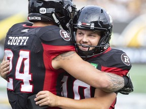 Ottawa Redblacks kicker Lewis Wardduring is hugged by teammate Anthony Cioffi after his final field goal of the game during second half CFL football game action against the Hamilton Tiger-Cats in Hamilton, Ont. on Saturday, July 28, 2018.