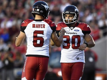 Calgary Stampeders kicker Rene Paredes (30) celebrates a kick with punter Rob Maver (6) against the Ottawa Redblacks during first half CFL action in Ottawa on Thursday, July 12, 2018.