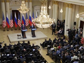 U.S. President Donald Trump, left, and Russian President Vladimir Putin hold a press conference after their meeting at the Presidential Palace in Helsinki, Finland, Monday, July 16, 2018.