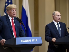 U.S. President Donald Trump speaks as Russian President Vladimir Putin listens during a join press conference at the Presidential Palace in Helsinki, Finland, Monday, July 16, 2018.