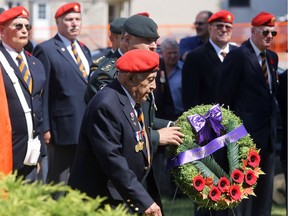 Second World War veteran Austin Fuller of the Tyendinaga Mohawk Territory walks with Lt.-Col. Chris Comeau, commanding officer of the Hastings and Prince Edward Regiment, during a service commemorating the 75th anniversary of the Allied invasion of Sicily Tuesday, July 10, 2018 in Belleville, Ont. Together they laid a wreath on behalf of the Mohawks of the Bay of Quinte band. Luke Hendry/Belleville Intelligencer/Postmedia Network