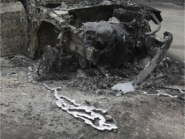 Melted metal from a burned-out car that was destroyed in the wildfires near the village of Neos Voutzas near Athens, Tuesday, July 24, 2018. Greece sought international help through the European Union as fires on either side of Athens left lines of cars torched, charred farms and forests, and sent hundreds of people racing to beaches to be evacuated by navy vessels, yachts and fishing boats.(AP Photo/Yorgos Karahalis) ORG XMIT: TH135