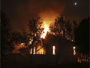 A house burns in the town of Mati, east of Athens, Monday, July 23, 2018. Regional authorities have declared a state of emergency in the eastern and western parts of the greater Athens area as fires fanned by gale-force winds raged through pine forests and seaside settlements on either side of the Greek capital.