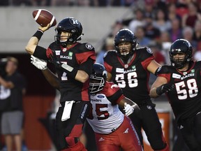 Ottawa Redblacks quarterback Trevor Harris (7) tries to avoid Calgary Stampeders' Ja'Gared Davis during the first half on Thursday, July 12, 2018, in Ottawa. (JUSTIN TANG/THE CANADIAN PRESS)