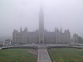 The Canadian flag on top of the Peace Tower was shrouded in fog Thursday.