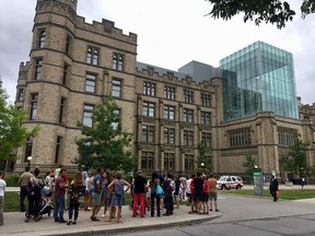 Patrons continue to wait outside the Museum of Nature after an evacuation. 
Wayne Cuddington photo