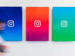 An employee walks past branded posters displayed at the Instagram Inc. office in New York, U.S., on Monday, June 4, 2018. Once, Instagram was a simple photo-sharing app, a way for iPhone shutterbugs to show off their latest cool pics. Now, its visual nature and 1 billion active users have sellers salivating over its potential as a place to sell everything from dresses to furniture.