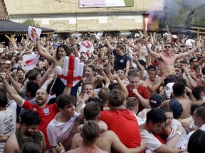 England soccer fans celebrate on the final whistle as they watch a live broadcast on a big screen of the quarterfinal match between England and Sweden at the 2018 soccer World Cup, in Flat Iron Square, south London, Saturday, July 7, 2018.