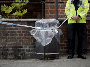 FILE - In this file photo dated Thursday, July 5, 2018, an unidentified British police officer guards a cordon in Salisbury, England. Officials say Saturday July 7, 2018, that a police officer is being tested for possible medical problems related to the recent Novichok nerve agent poisoning of two individuals in southwest England.