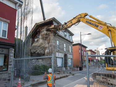The initial stage of demolition for the Magee House begun on Friday night with crews taking down the south west corner of the building hoping that would be enough to make the building stable enough and the street could be opened to traffic. No decision has been made on whether restoration is a solution or complete demolition.   Photo by Wayne Cuddington/ Postmedia