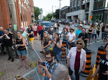 Passersby look on as the initial stage of demolition for the Magee House begun on Friday night with crews taking down the south west corner of the building hoping that would be enough to make the building stable enough and the street could be opened to traffic. No decision has been made on whether restoration is a solution or complete demolition.   Photo by Wayne Cuddington/ Postmedia