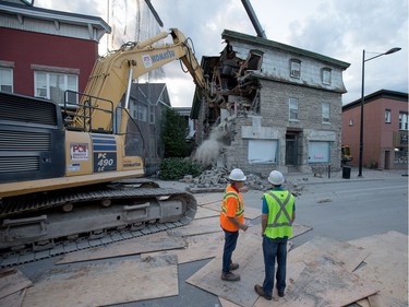 The initial stage of demolition for the Magee House begun on Friday night with crews taking down the south west corner of the building hoping that would be enough to make the building stable enough and the street could be opened to traffic. No decision has been made on whether restoration is a solution or complete demolition.   Photo by Wayne Cuddington/ Postmedia