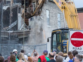 The initial stage of demolition for the Magee House begun on Friday night with crews taking down the south west corner of the building hoping that would be enough to make the building stable enough and the street could be opened to traffic. No decision has been made on whether restoration is a solution or complete demolition.   Photo by Wayne Cuddington/ Postmedia