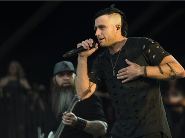 Guitarist Barry Stock, left, and Lead vocal Matt Walst from the Canadian rock band Three Days Grace performs on the last day of Bluesfest in Ottawa on July 15, 2018.