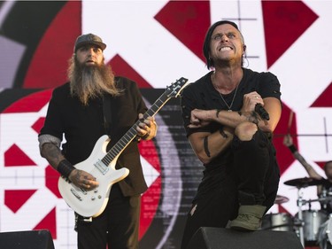 Guitarist Barry Stock and Lead vocal Matt Walst (R)  from the Canadian rock band Three Days Grace performs on the last day of Bluesfest in Ottawa on July 15, 2018.