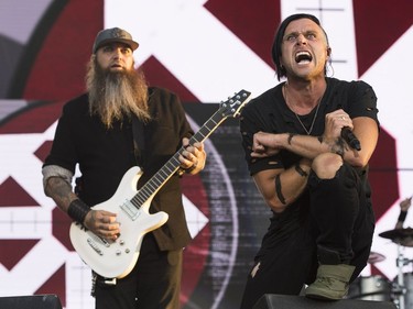 Guitarist Barry Stock, left, and lead vocal Matt Walst (R)  from the Canadian rock band Three Days Grace performs on the last day of Bluesfest in Ottawa on July 15, 2018.