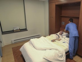 A technician prepares equipment to monitor Martin Braun's brain activity during a sleep study at the New York-Presbyterian/Weill Cornell Medical Center in New York on Wednesday June 27, 2018. Braun, 76, stopped using his noisy CPAP machine and awkward mask, but now he's trying again after a car crash when he fell asleep at the wheel. "That's when I realized, OK this is serious stuff already," said Braun, who has ordered a quieter CPAP model.